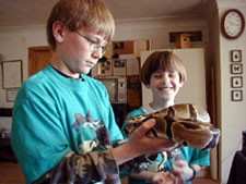 2 boys with snake